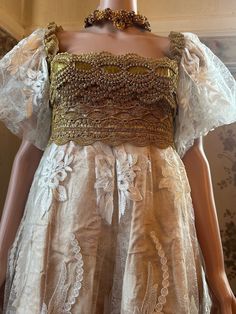 This is a  very special Bridal gown, so unique and elegant.! It was designed for a special wedding celebration ... if you plan a wedding with  historical theme, medieval, Shakespeare in love, Napoleon's Empire, or even 1960's ! This is a good dress for you.   And   if you want to wear a long veil to the ground, the style now looks 1920th  This is  a very clever and multifaceted dress...that's why is so attractive. The fabric is a beautiful vintage silk and cotton damask brocade champagne color,  It was woven with golden thread as well, and you can see  a layer of shine, discreetly when you move... very nice. The Dress is overlaid by a very fine and sheer White Cord Lace with a floral motif. Not so vintage but we cannot find it anymore, is a very beautiful lace.  The dress is  A-line style Medieval Romance, Shakespeare In Love, Lame Fabric, Golden Thread, Long Veil, Cord Lace, Vintage Champagne, Brocade Dresses, Corded Lace