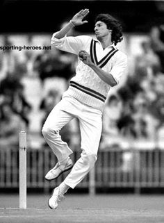 a black and white photo of a man playing cricket