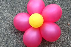 a bunch of balloons that are laying on the ground with one balloon in the middle