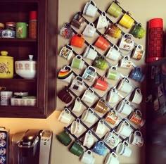 a wall mounted coffee mug rack with cups on it