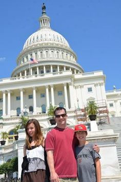 three people standing in front of the capitol building