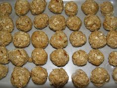 several balls of oatmeal are on a baking sheet and ready to be baked