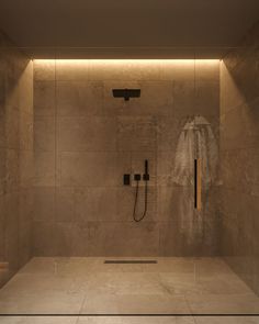 an empty bathroom with a shower head and hand held shower faucet in the corner