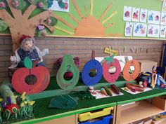 a child's play area with toys on the table and in front of it