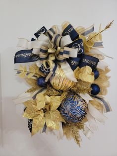 a blue and gold christmas ornament hanging on a wall