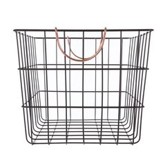 a black wire basket with a brown leather handle on the front and bottom, against a white background