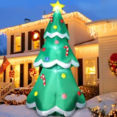 a large christmas tree in front of a house