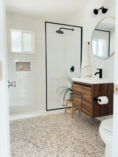 a bathroom with a sink, toilet and shower