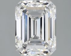 an emerald cut diamond on a gray background with the center stone in white and black