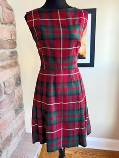 VINTAGE 1950's PLAID PLEATED DRESS WOOL RED, GREEN, AND WHITE PLAID PLEATED DRESS/JUMPER WITH METAL ZIPPER AND UNION TAGS MEASUREMENTS ARE TAKEN FLAT, DOUBLE WHERE NECESSARY- *LENGTH- 35.5" *WAIST-13" *BUST- 16" *SLEEVE- 7" OPENING *SHOULDER TO SHOULDER - 15" *HIP-16-18" *ZIPPER-19" Dress is in EXCELLENT CONDITION! Plaid A Line Dress, Vintage Plaid A-line Dress, Vintage Lined Plaid Dress, Red Plaid Dress Outfit, Vintage Christmas Dress, 1960 Fashion, Red Plaid Dress, Vintage 1950s Dresses, Wool Dress