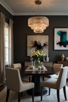 a dining room table with four chairs and a chandelier hanging from the ceiling