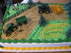 a birthday cake with farm animals and tractors on the top is decorated in green frosting