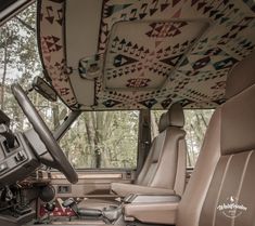 an interior view of a vehicle with leather seats and quilted covers on the roof