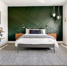 a bedroom with green walls and white bedding