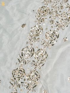 gold and silver sequins on white fabric