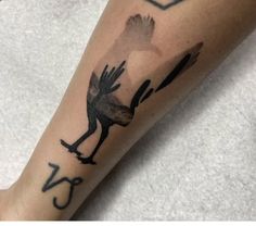 a person with a bird tattoo on their arm and the number twenty five behind it