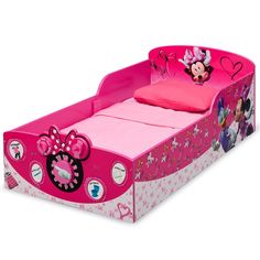 a child's bed with minnie mouse head on the side and pink bedspread