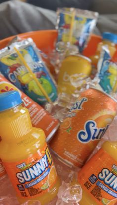 orange juice and sunscreen are arranged in a basket