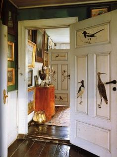 an open door with birds painted on it