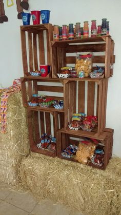 the shelves are made out of wood and have food in them on top of straw