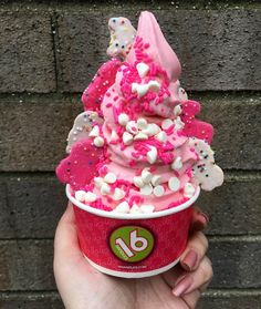 a pink ice cream with sprinkles on top