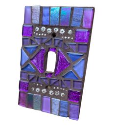 a purple and blue mosaic light switch cover