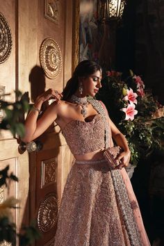 Pakistani Bridal Dress in Pink Lehenga and Choli Style has a perfect balance of style and elegance. This stunning Bridal Lehenga Choli is a trendy masterpiece adorned with Embroidery and hand-crafted details of embellishments, making it an epitome of beauty and grace. Lehenga Choli: The choli is in an alluring pink color is heavily embellished with intricate designs, zardosi, dabka, and silverwork. The shimmering details and lavish embroidery on the choli make it a perfect choice to pair with Lehenga. The choli has no sleeves which give this attire a modern look. Bridal Lehenga: This Bridal Lehenga comes in premium silk fabric and is emblazoned with the intricate dabka, kora, shimmering silver work, and tilla. Sequins, motifs, zardosi, and Resham make this Lehenga an epitome of beauty. The Lavender Bridal Lehenga, Choli Style, Bridal Lehenga Pakistani, Pakistani Bridal Lehenga, Wedding Dresses Pakistani, Bridal Mehndi Dresses, Pakistani Bridal Dress, Walima Dress, Zardozi Work