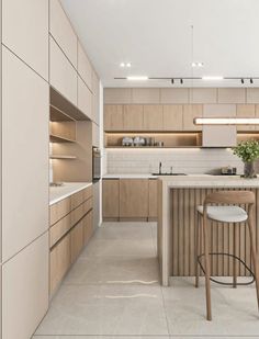 a modern kitchen with an island counter and stools in the center, surrounded by wooden cabinets