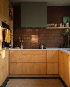 a kitchen with wooden cabinets and white counter tops