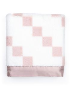 a pink and white blanket with squares on it