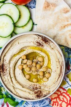 hummus and cucumber with pita bread on the side, ready to be eaten