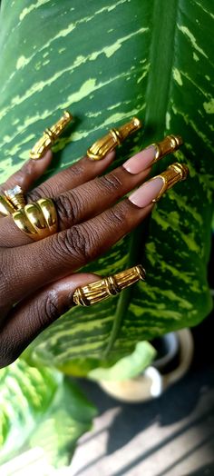 Your inner ghetto girl and 90s child dreams are realized. This iconic nail set draws inspiration from the timeless bamboo hoop earrings. Each design features intricate gold detailing that mimics the look of real, welded gold, adding a touch of sophistication and craftsmanship. The combination of classic shapes and modern detailing creates a bold, stylish look that seamlessly blends tradition with contemporary flair. Ideal for those who appreciate unique, fashion-forward accessories, this set bri Funky Brown Nails, Kente Cloth Nail Art, Gold Jewelry Nails, Simple Freestyle Nails, All Gold Nails, Afrocentric Nails, Guitarist Nails, Gold Nails Inspiration, Green And Gold Nails Acrylic