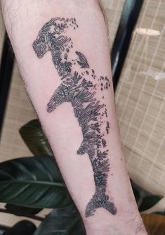 a man with a tattoo on his arm that has a horse in the middle of it