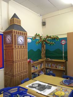 a classroom with a clock tower on the wall and children's bookshelves