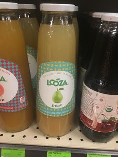 several bottles of juice are on the shelf