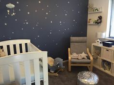 a baby's room with stars painted on the wall