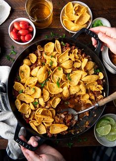 a skillet filled with tortilla chips and salsa