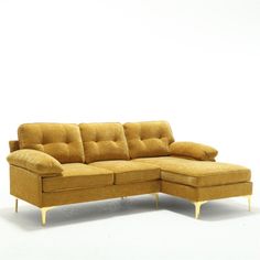 a yellow sectional couch with pillows on it