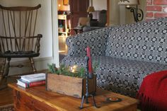 a living room filled with furniture and a fire place next to a chair on top of a wooden table