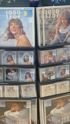 several cds are stacked on top of each other in a store display case for sale