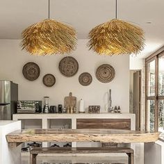 a dining room table and some lights hanging from the ceiling