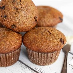 four muffins sitting on top of each other next to a knife and fork