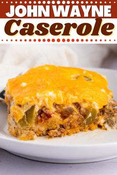 a close up of a slice of casserole on a plate with a fork