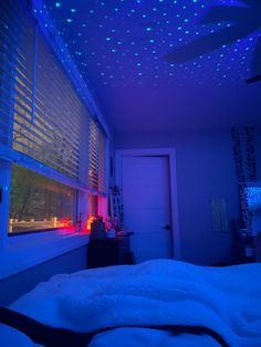 a bedroom with blue lights on the ceiling