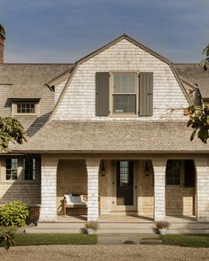 a white house with brown shutters and windows