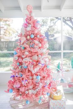 a pink christmas tree decorated with candy canes