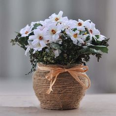 a basket filled with white flowers sitting on top of a table