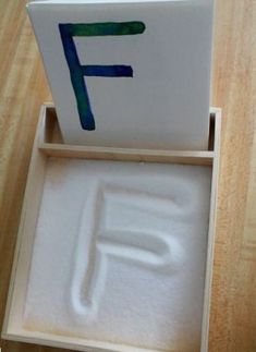 an open box with the letter f in it