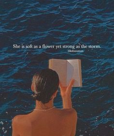 a woman sitting in the water reading a book with an inspirational quote above her that reads, she is soft as a flower yet strong as the storm