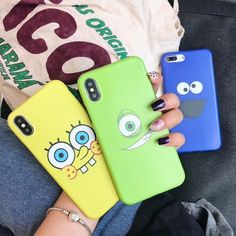 two people holding up their cell phones with the same phone cases on them, one is green and one is blue